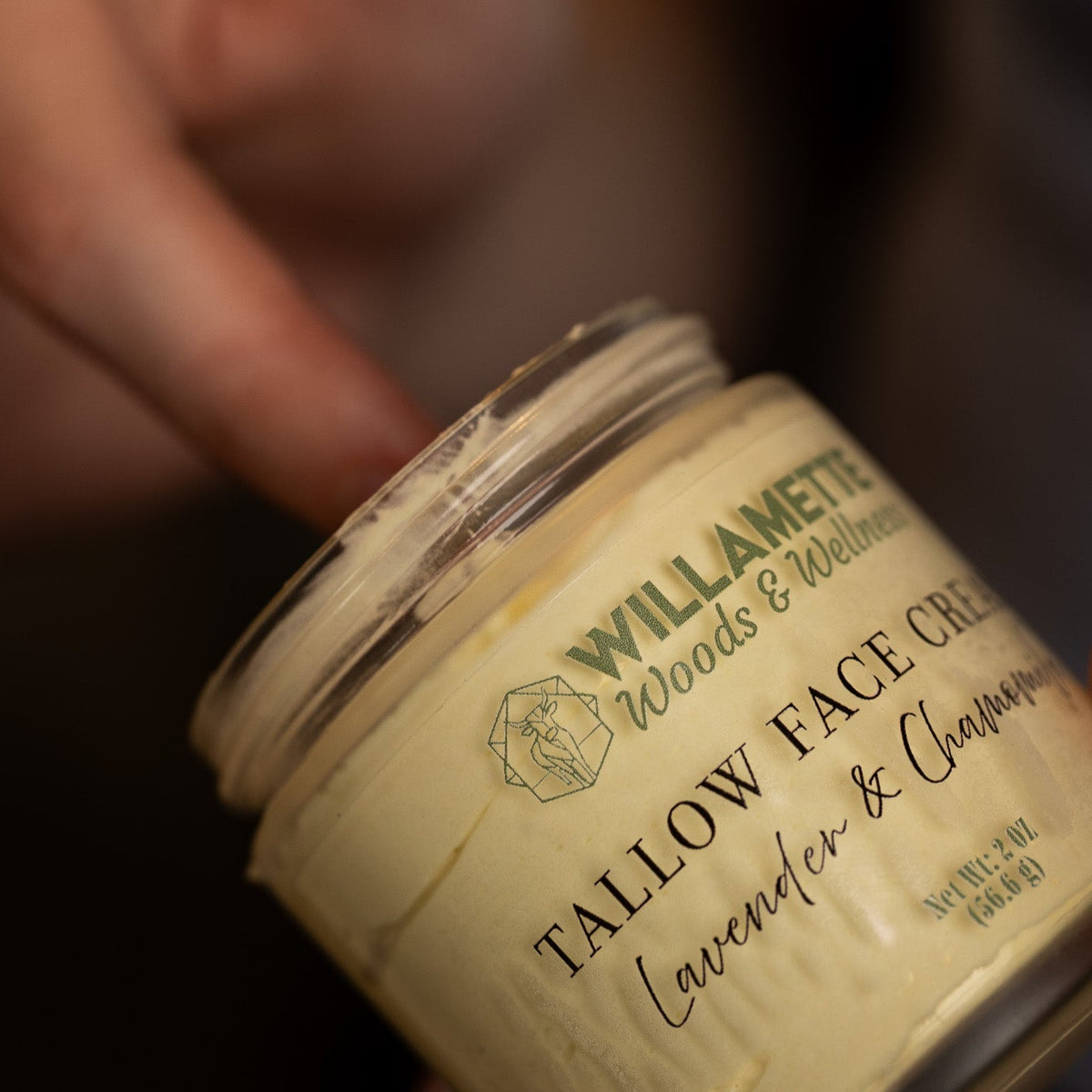tallow face cream with creamy texture on fingers