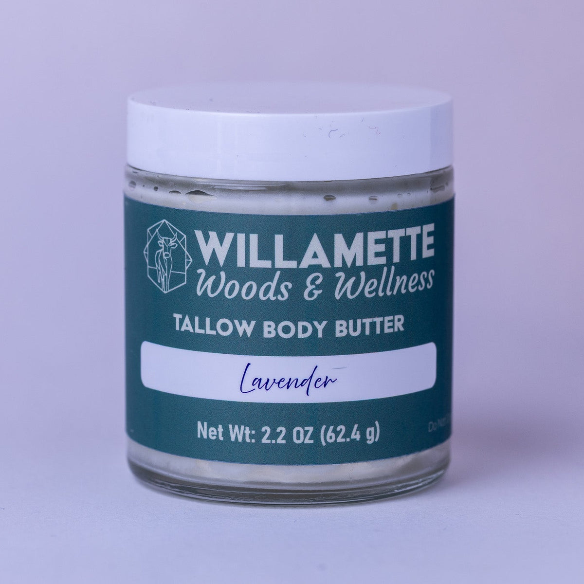 Jar of Willamette Woods & Wellness lavender tallow body butter on a light purple background