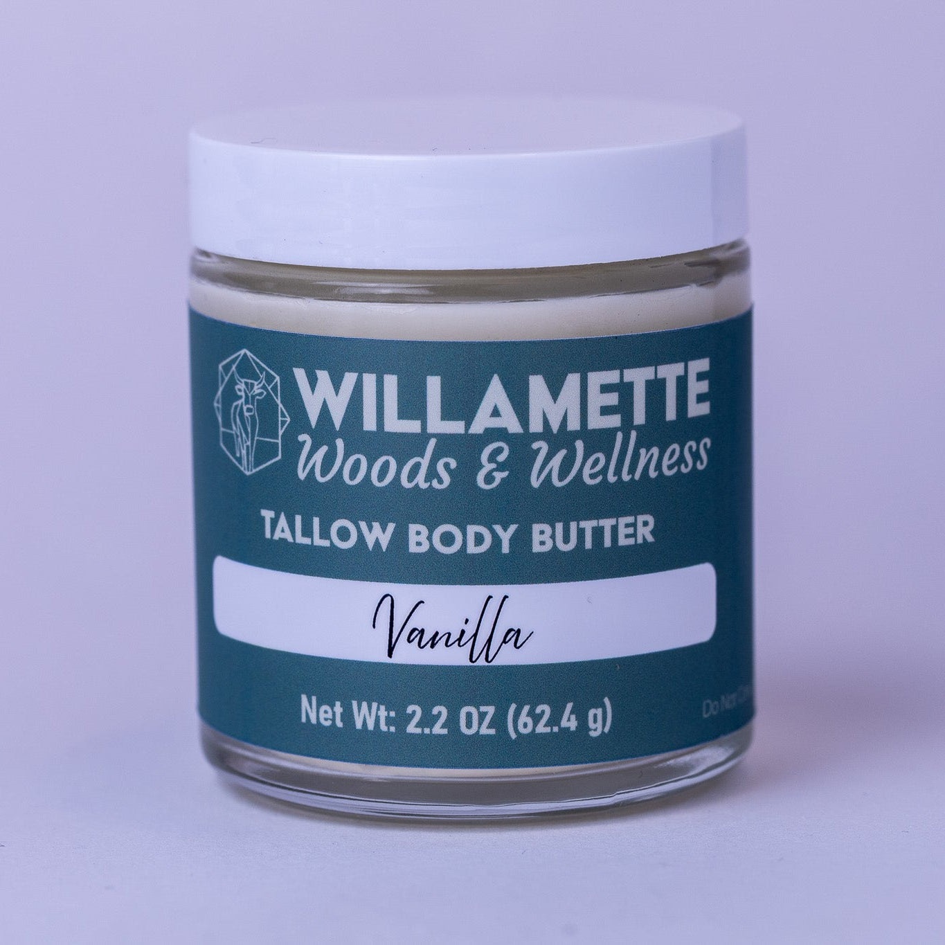 Jar of Willamette Woods & Wellness Tallow Body Butter with vanilla scent on a light purple background