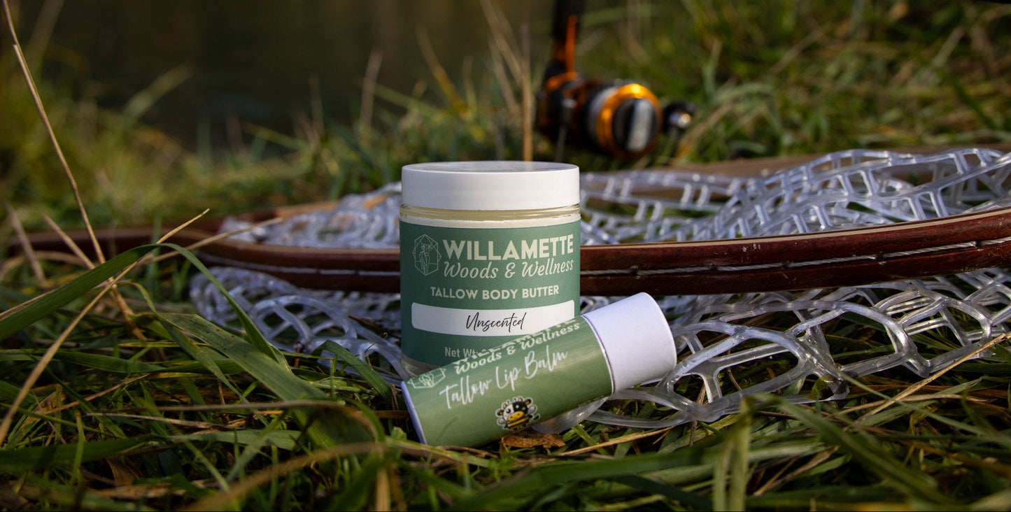 Willamette Woods & Wellness body butter and lip balm on a fishing net in a grassy field
