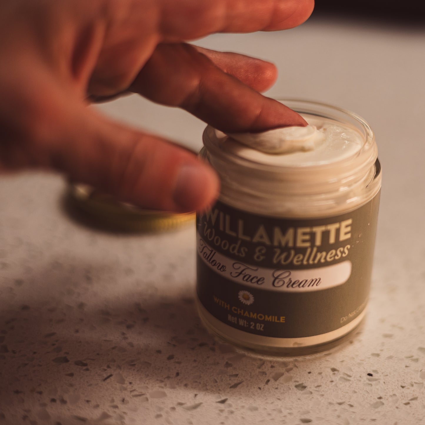 Hand dipping into Tallow Face Cream Jar
