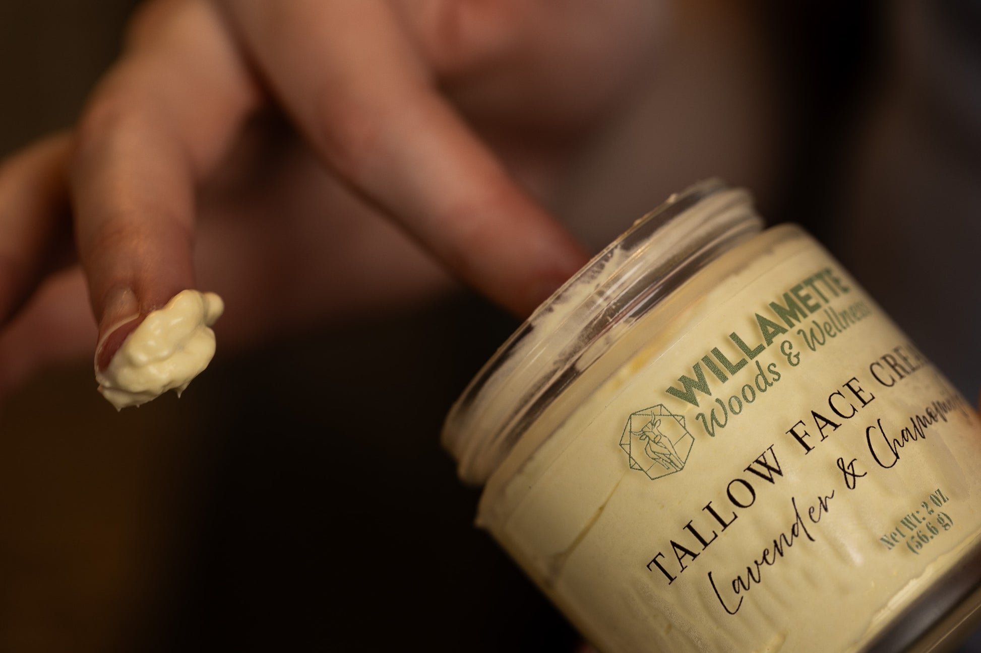 tallow face cream with creamy texture on fingers
